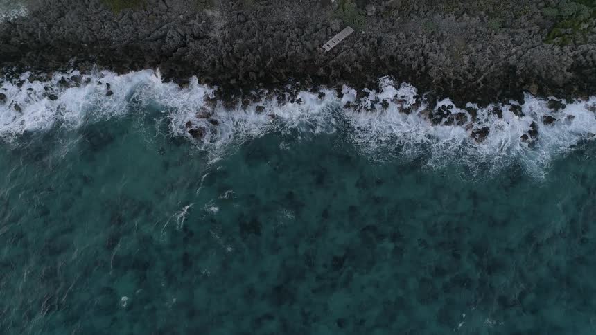 Waves crash along shoreline