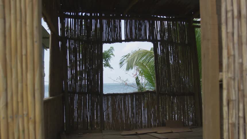 A bamboo shack with its window overlooking the ocean