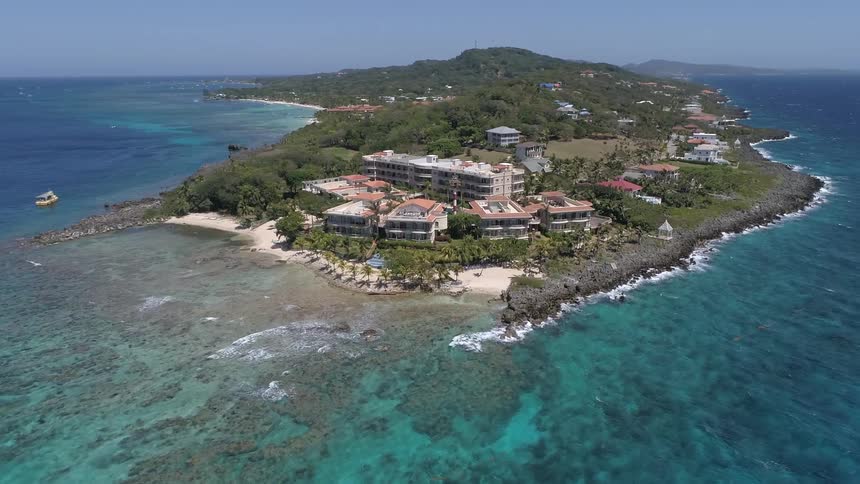 Ocean water sits next to a resort area