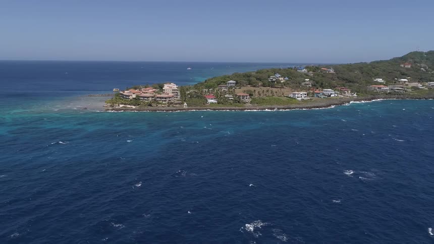 Coastal land with houses near the ocean