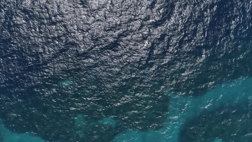 Beautiful clear water with rocks on the ocean bed