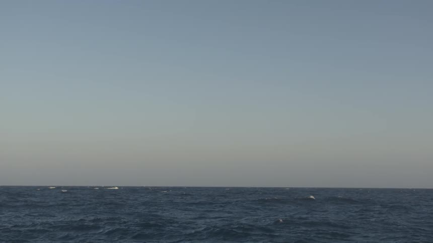 The ocean with waves breaking under a cloudy sky
