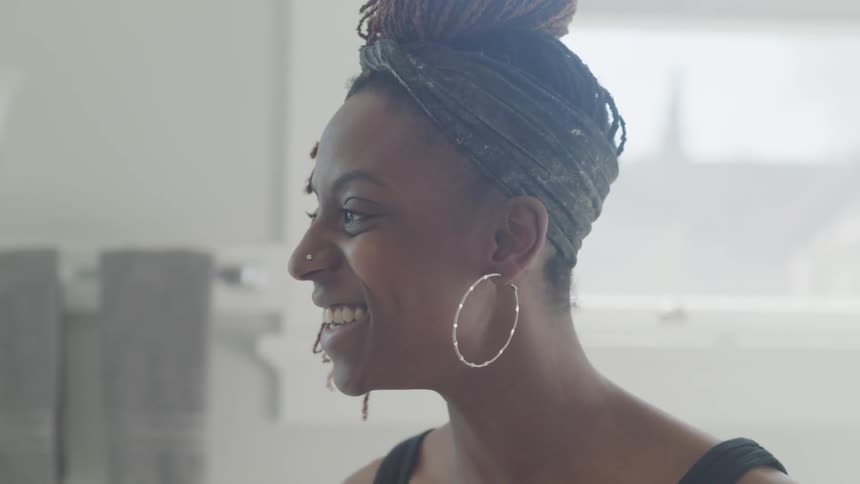 A woman is in a room smiling