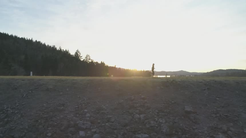 Girl running on a rocky hill side