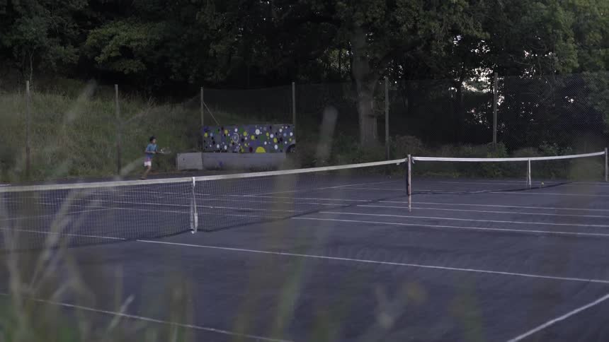 Athlete Playing Tennis On Court Outdoors Under Bright Daylight.