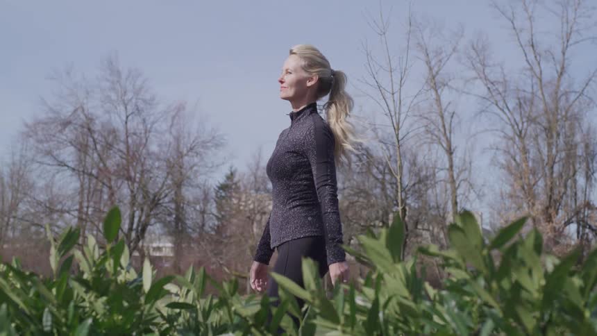 Woman walking next to plants