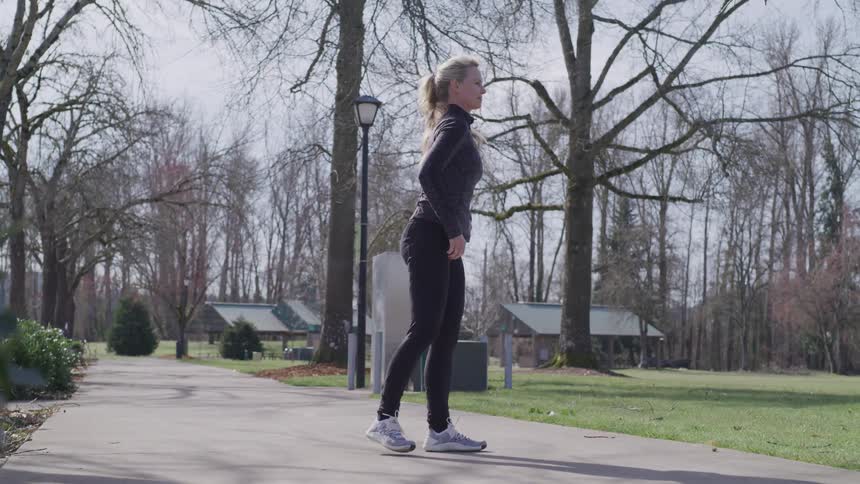 Girl tying her shoe inpark