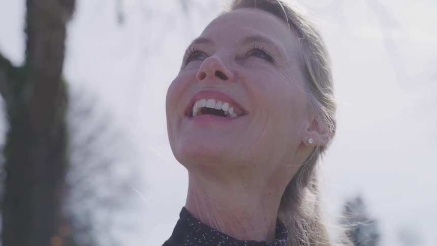A woman looks up smiling