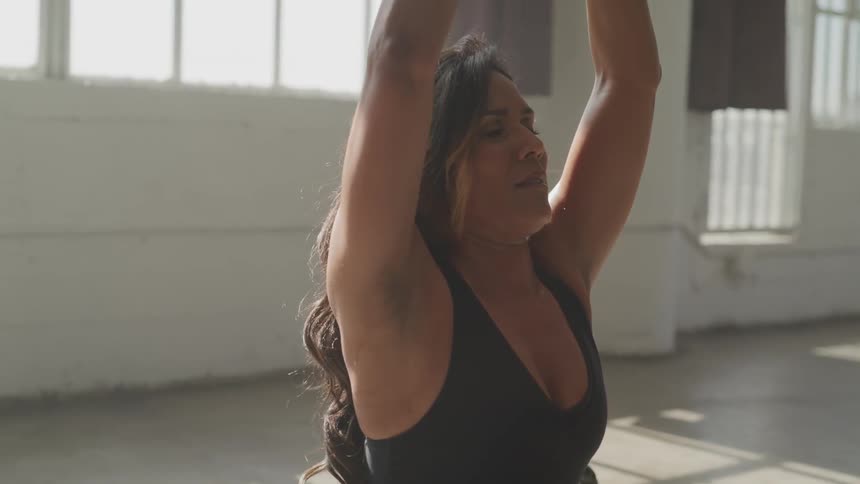 Woman lifting weights on a gym studio