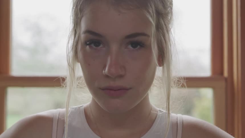 Girl standing in front of window