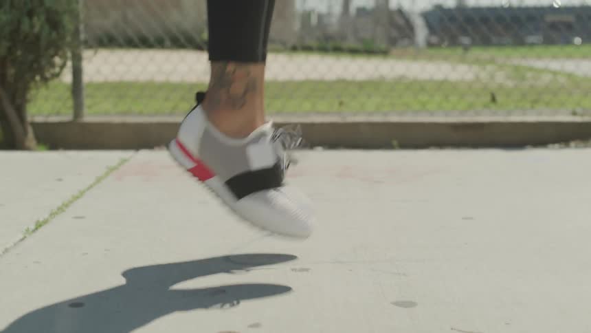 Someone with running shoes is exercising in the middle of park