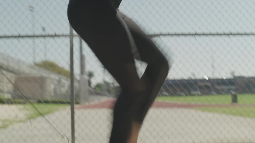 Woman jogs in place then runs across the pavement