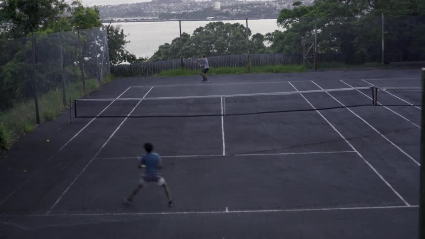 Outdoor Tennis Match: Two Players Playing on Tennis Court.
