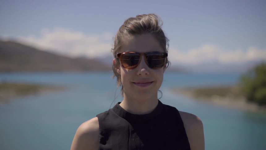 Women Wearing Sunglasses Outdoors Walking in Sunlight on Bright Clear Daytime Setting.