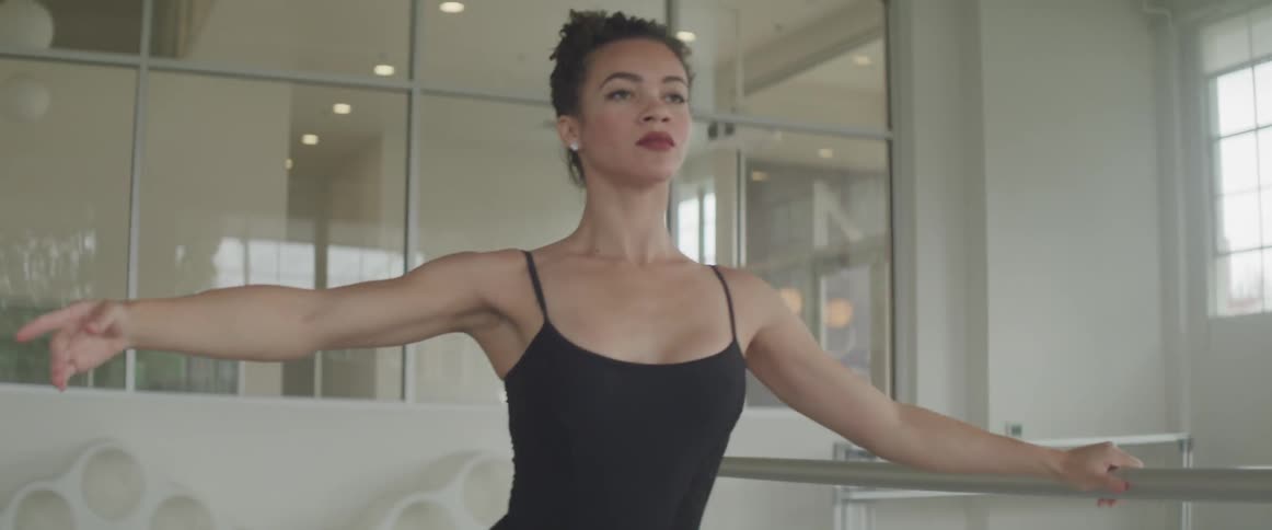A woman is doing ballet indoors