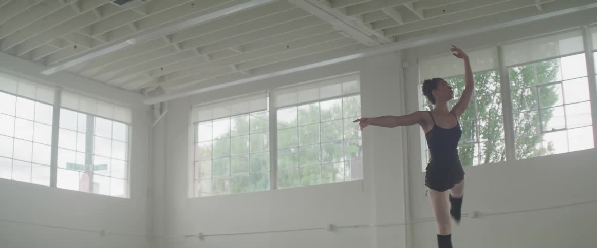 A ballerina is exercising in the white building