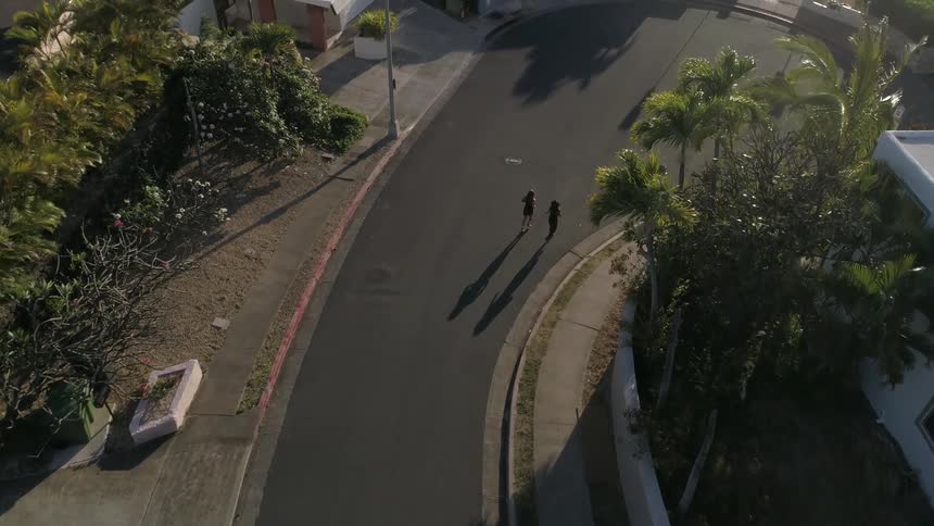 Two people are running in the neighborhood street