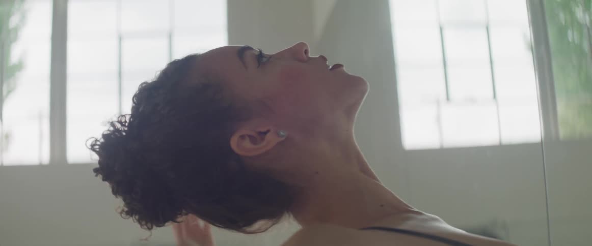 A ballerina dances in front of a mirror