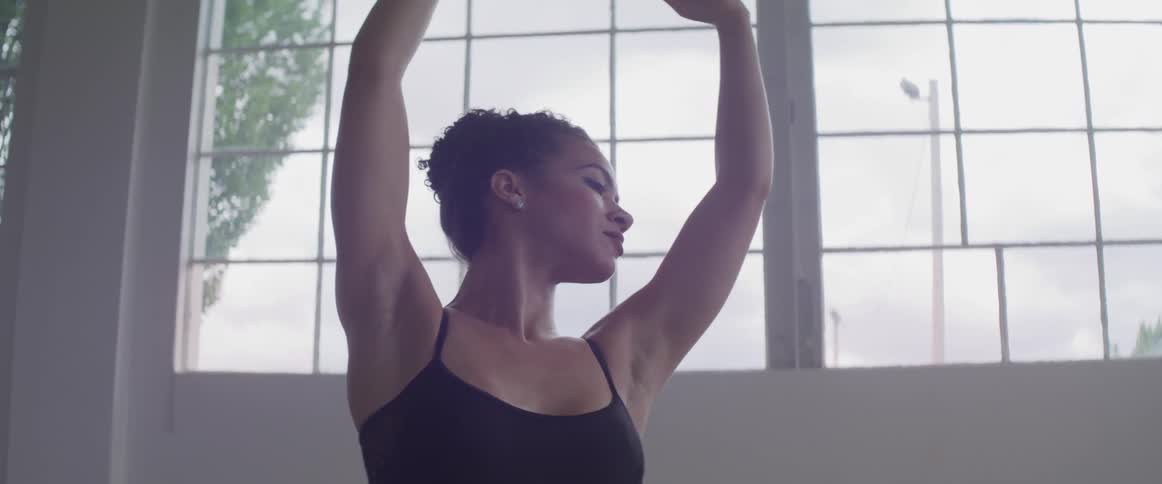 A woman is doing ballet indoors