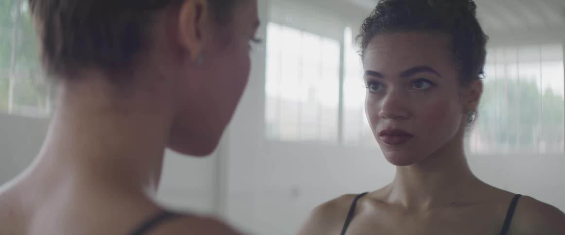 Girl looking in the mirror at herself