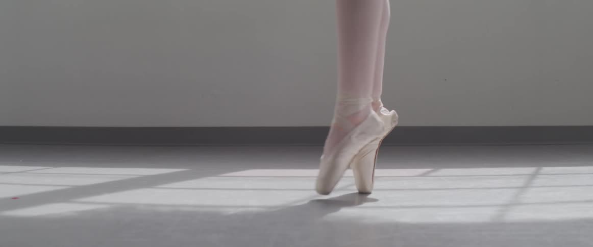 Ballerina feet twirling on toes in a studio