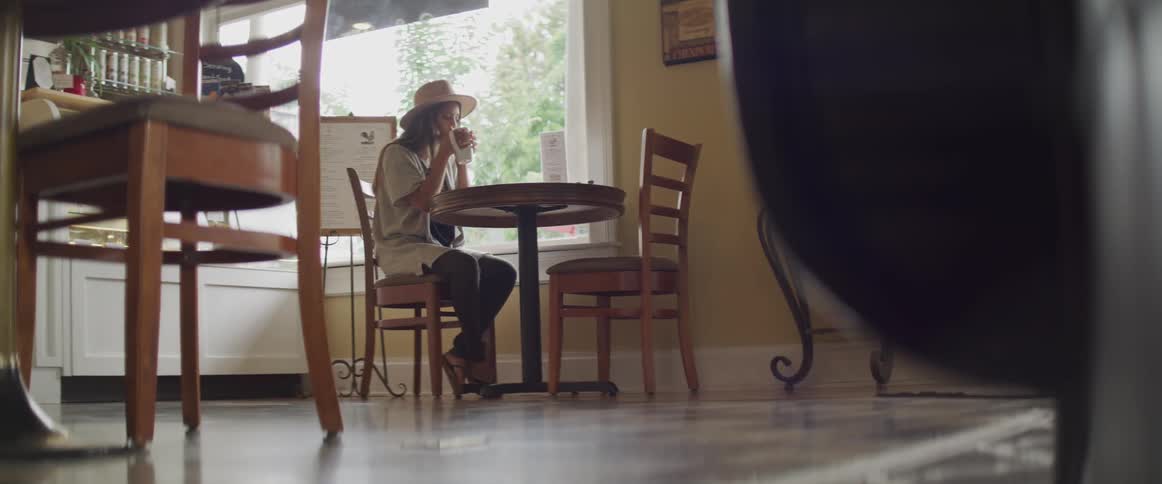 Girl sitting at a table in coffee shop