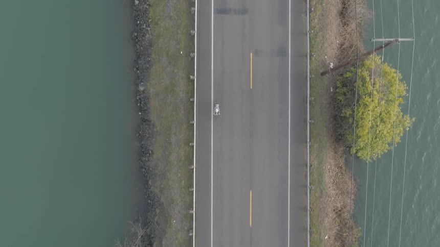Bicyclist riding next to water