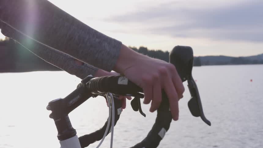 Someone riding a bike near a lake