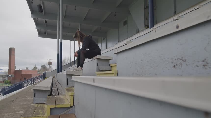 Girl sitting in the bleacher