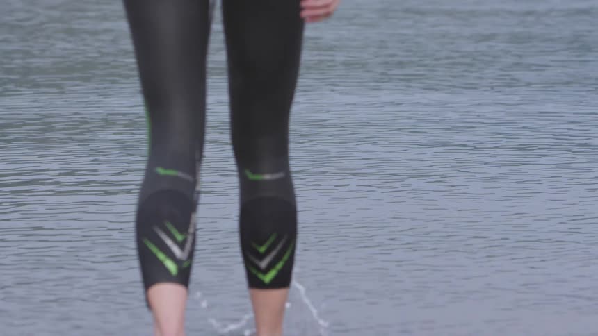 A person walks in to the water