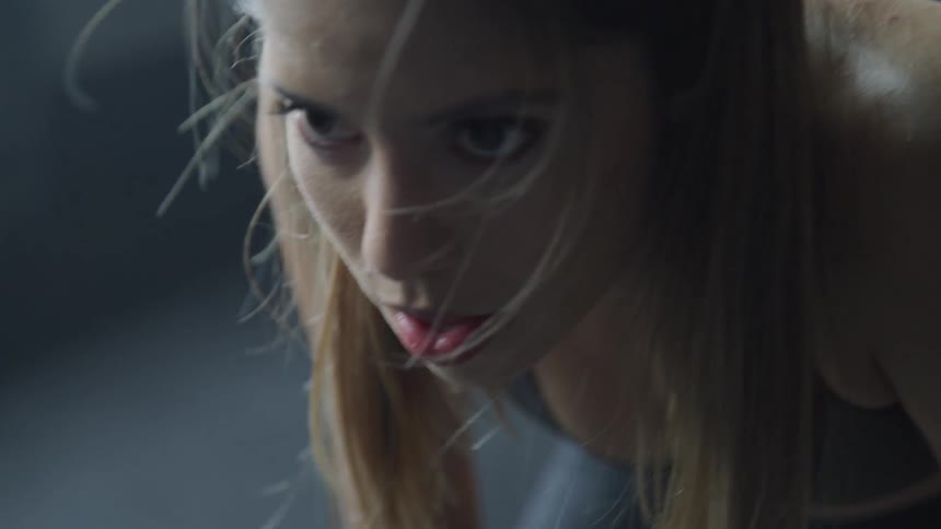 A woman is leaning forward resting