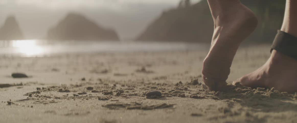A woman is standing on the beach
