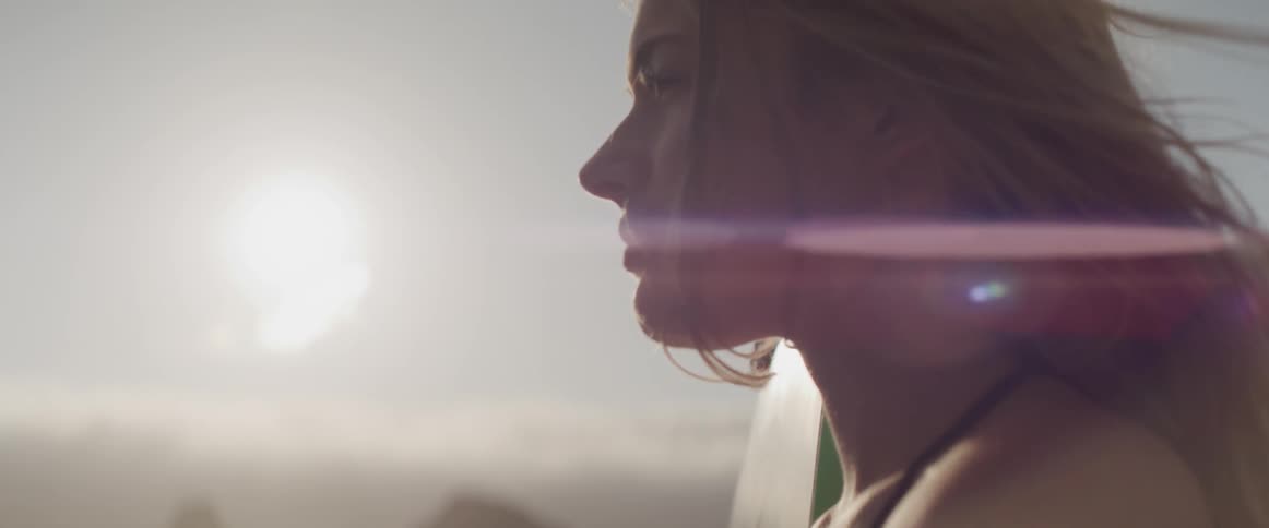 Wind blowing girl hair in sunlight