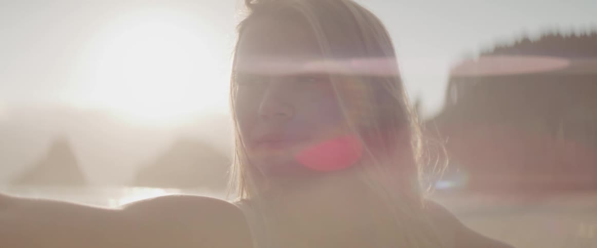 A woman closes her eyes while doing yoga outdoors