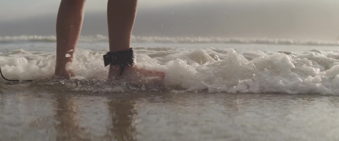 A person is walking on the coastline of an ocean