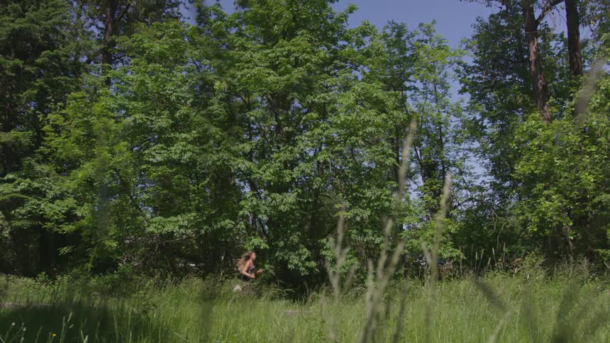 Female running outdoors on a trail in the forest