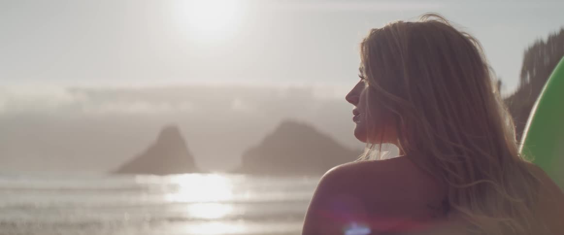 A woman looks out over the ocean
