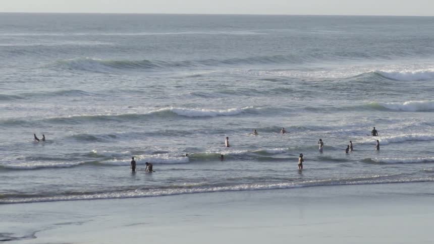 people spend a quiet moment in the waves, relaxing by the beach.
