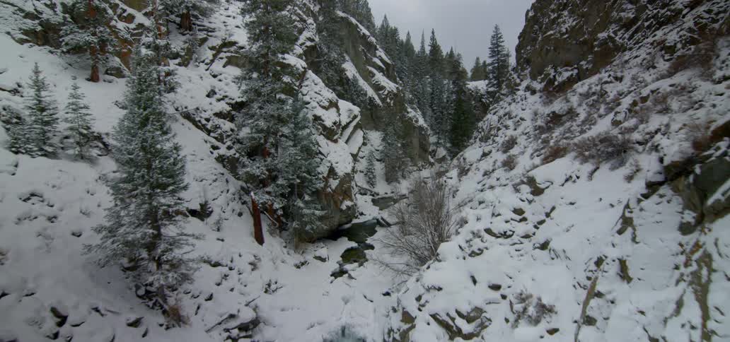 Aerial footage of a river running between mountains