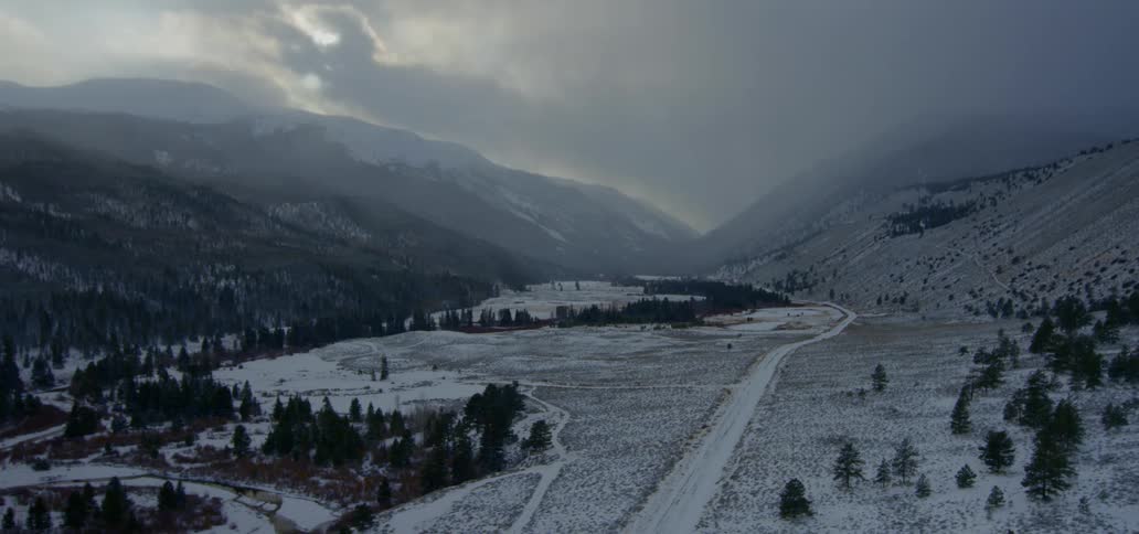 A scenery of mountain and grassland at winter