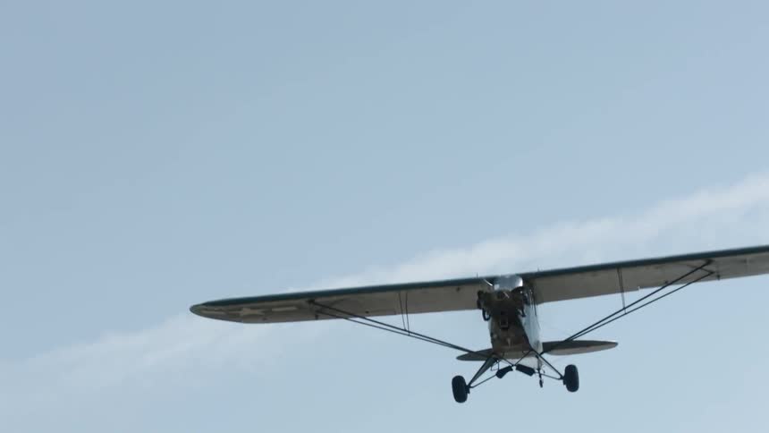 A single propeller plane flies through the sky