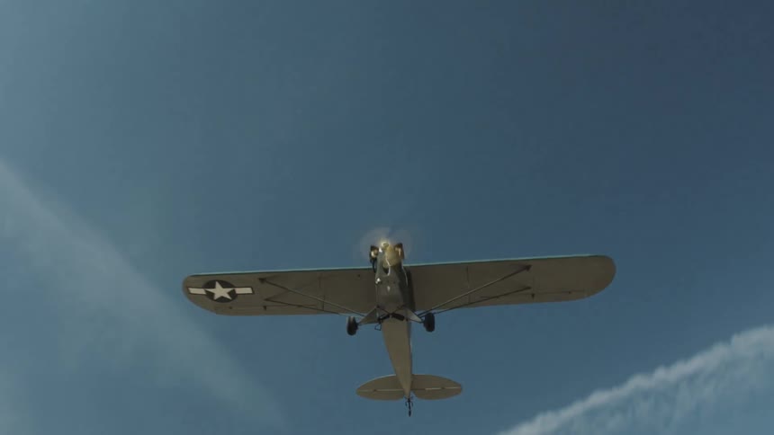 A small airplane flies through the sky