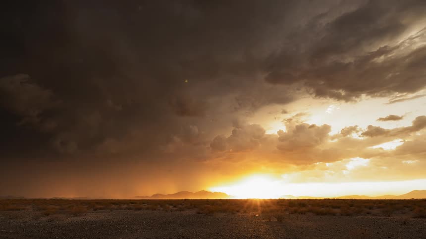 A desert with the sky and the clouds in the background