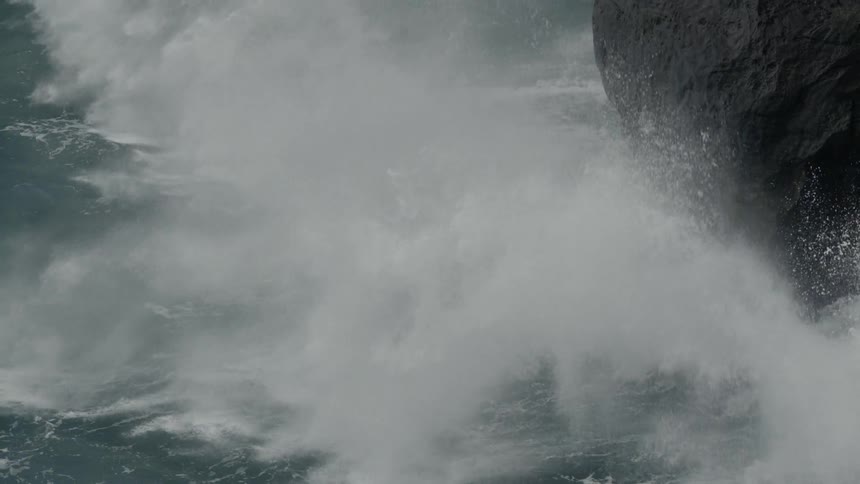 Waves splash against the rocks