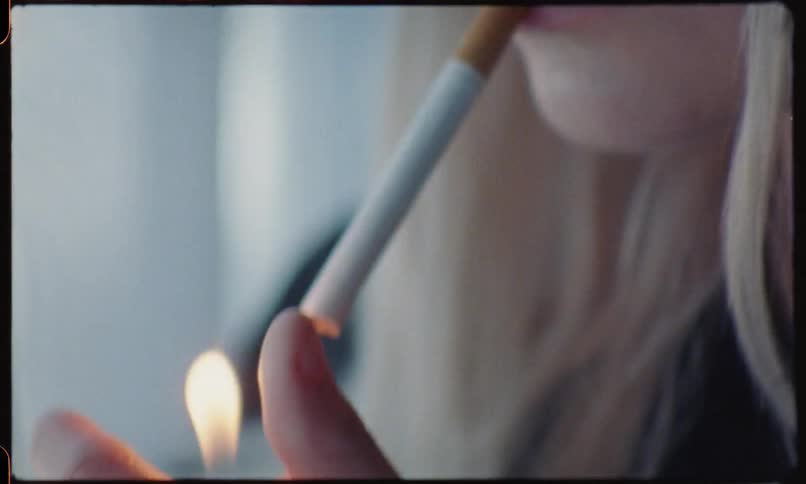 Blonde girl smoke cigarette