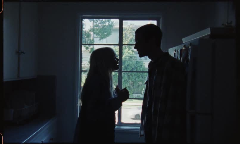Silhouette of couple arguing next to window light