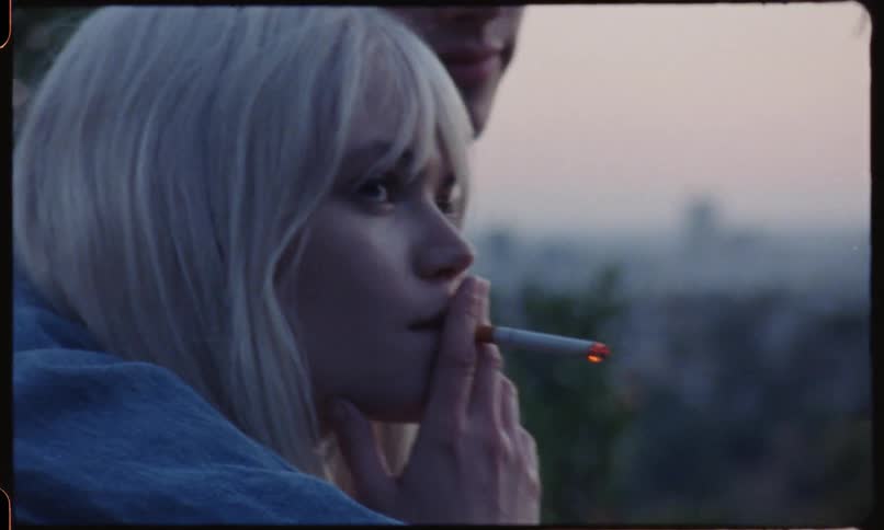 A couple smoking at sunset on the public park