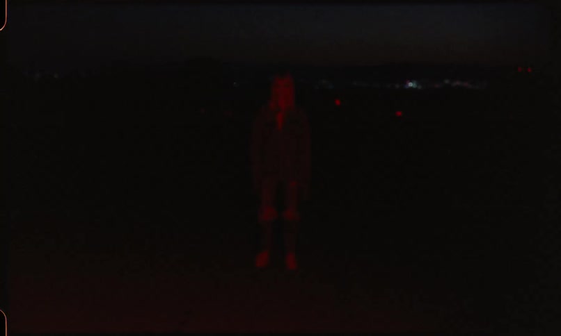 A portrait of a woman in red light fading