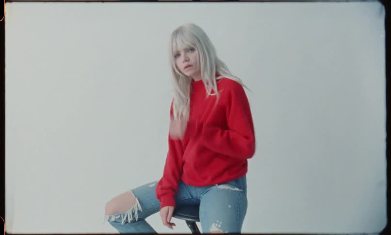 A teen model poses for a photographer