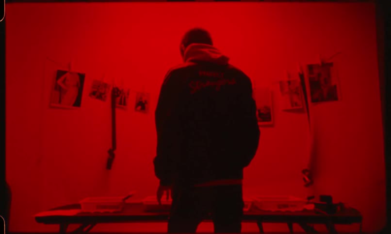 Man revealing pictures on darkroom